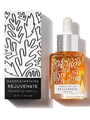 A sleek glass bottle of Bare, Thriving Rejuvenate Face Oil, surrounded by fresh botanical elements, emphasizing its natural and vegan formula